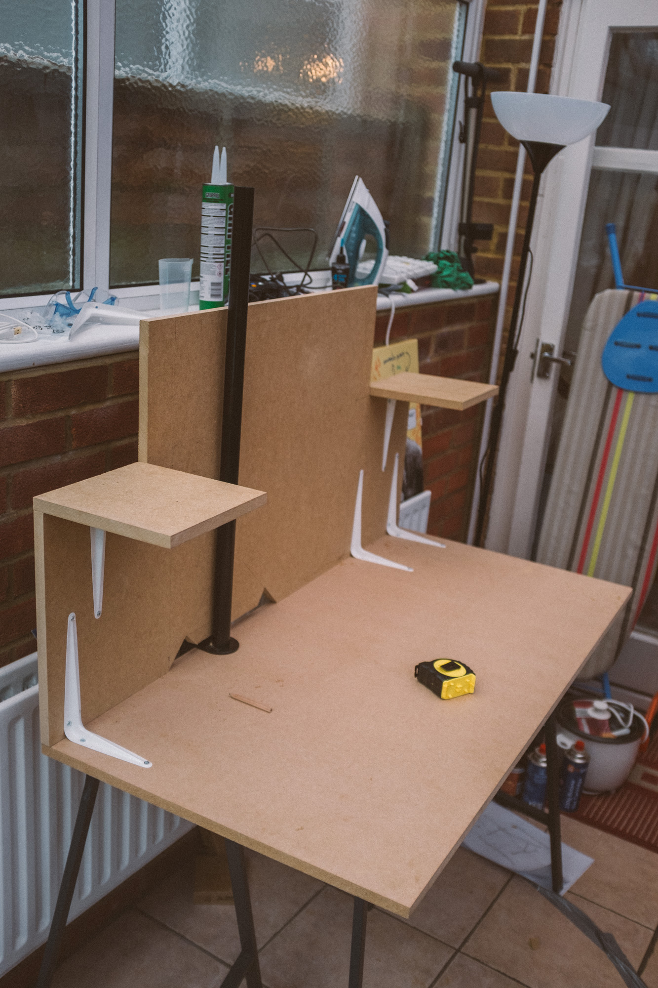 Speaker stand pole slotted into the slot at the back of the backplate, it is a black pole about 80cm in length that sits between the MDF and the PVC