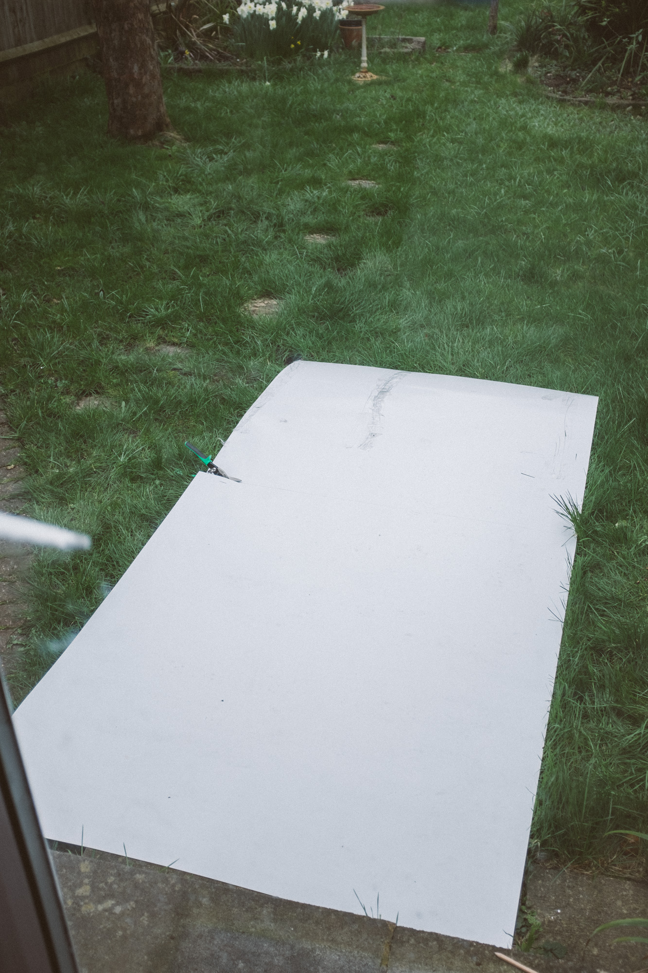 Big PVC sheet laid out on the grass of a garden