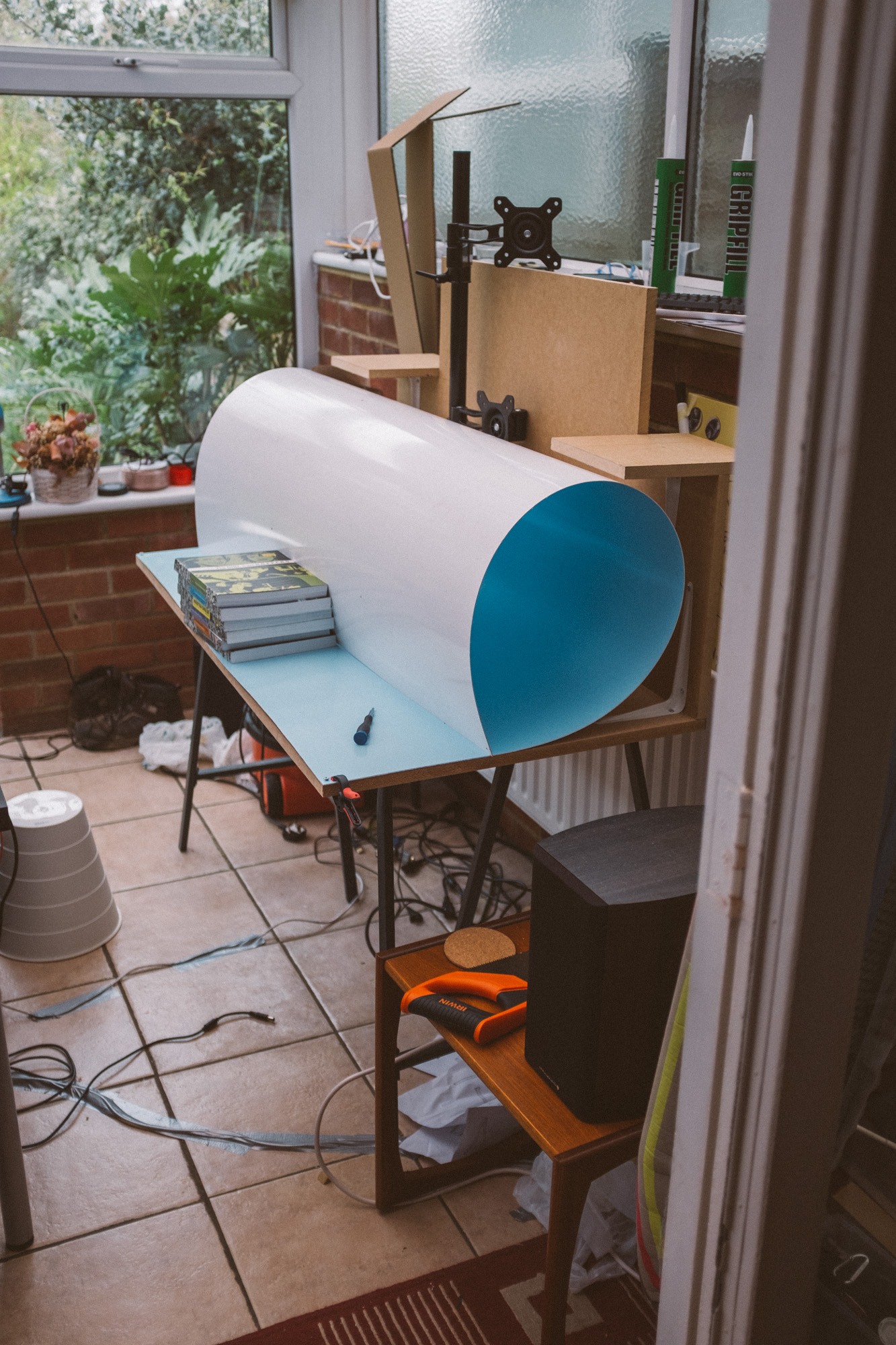 the PVC rolled up on the desk, books holding it in place