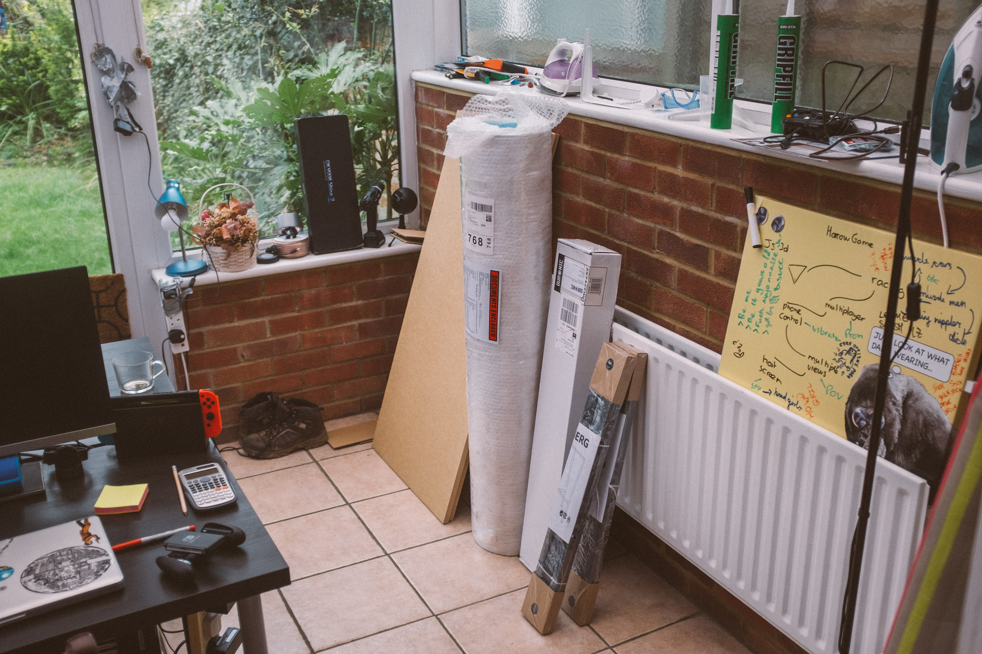 picture of materials listed below leant against a wall in a conservatory