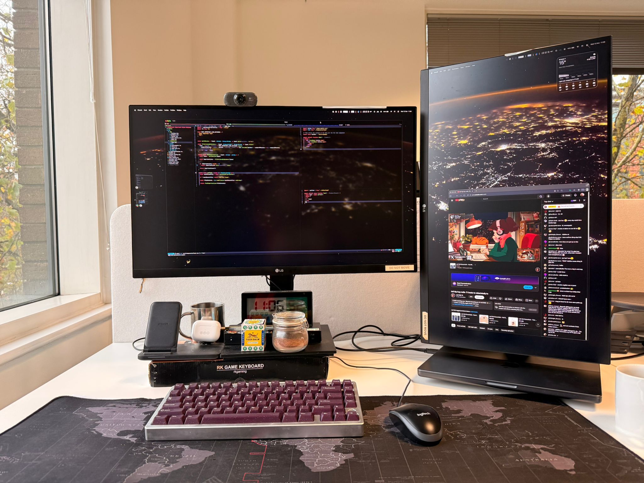 Picture of two screens, a keyboard and mouse on a white desk